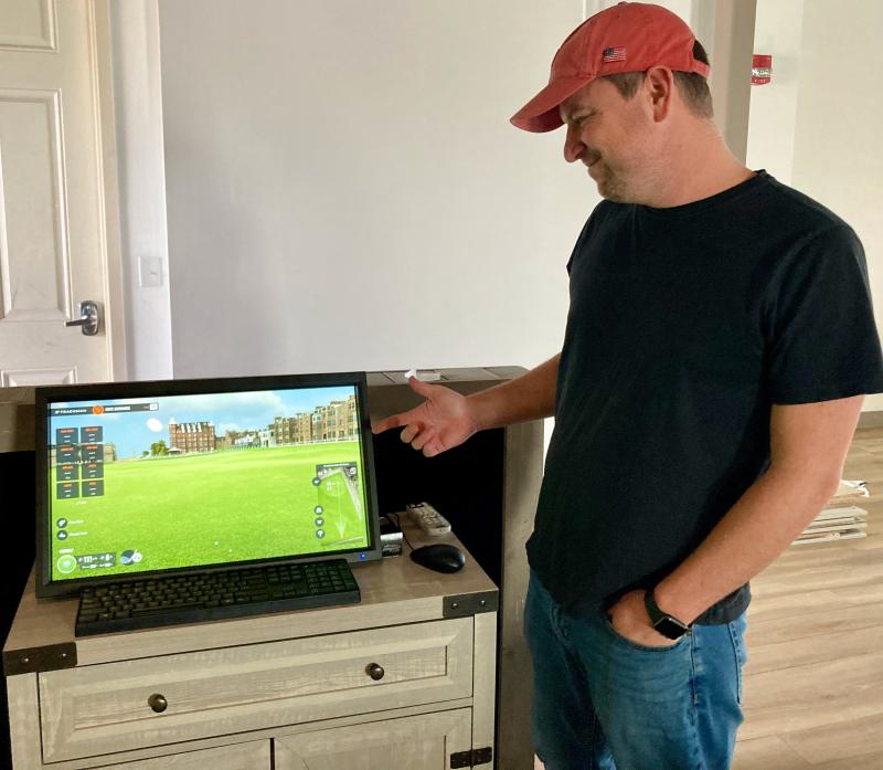 Dustin Smale, owner of the Foreland Club in Ocean View, shows off the shot display options available with the new Trackman 4 monitors that are at the heart of the new simulator venue. FRITZ SCHRANCK PHOTO
